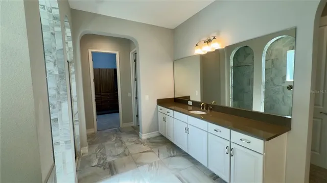 a view of a swimming pool with lawn chairs and plants