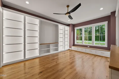 a spacious bathroom with a double vanity sink a large mirror and bathtub