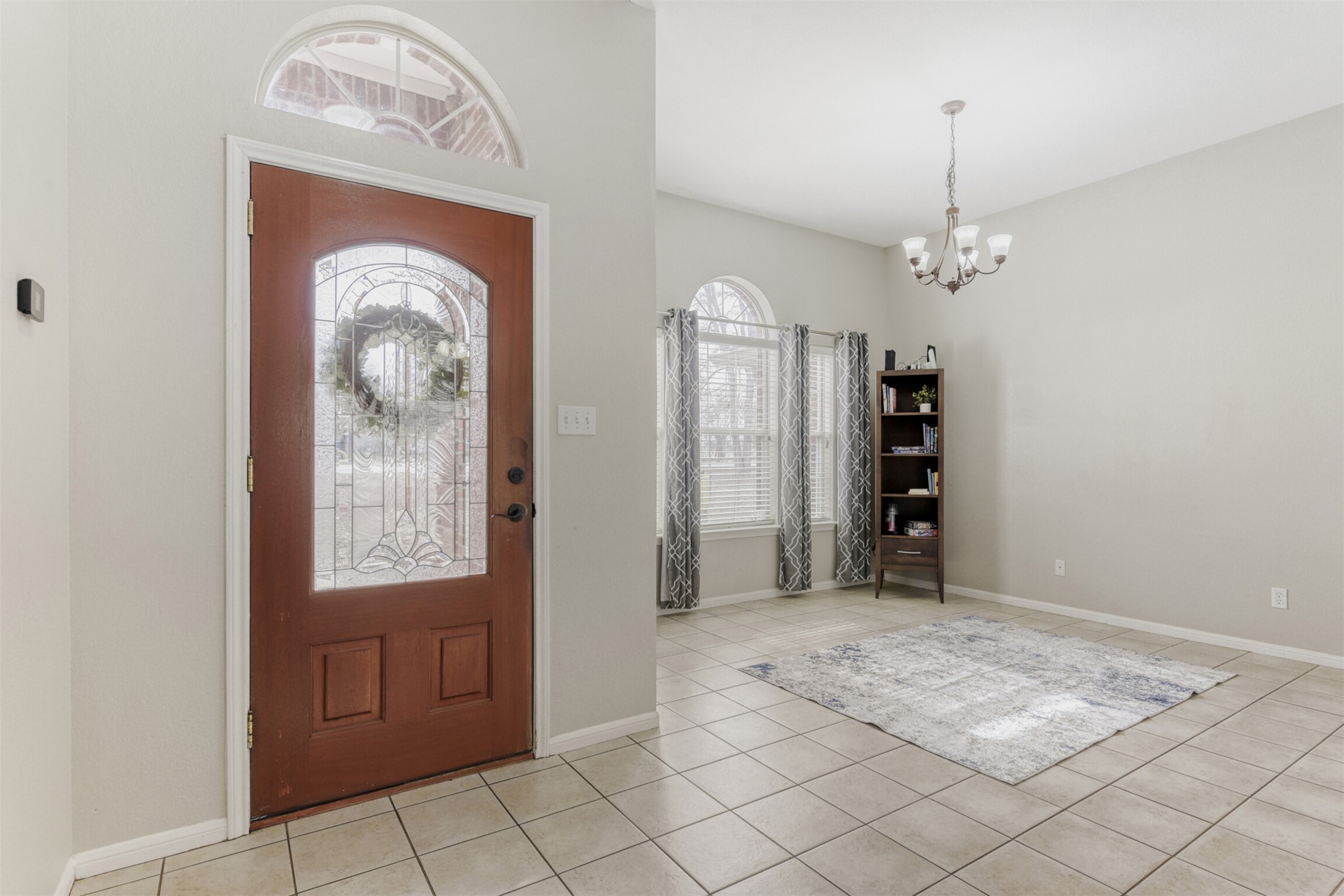 104 Spring Branch Bastrop, TX 78602 - Photo 10 of 32 Foyer with a chandelier and light tile patterned floors