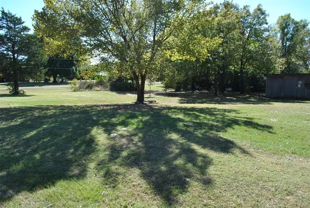 a swimming pool with trees in the background