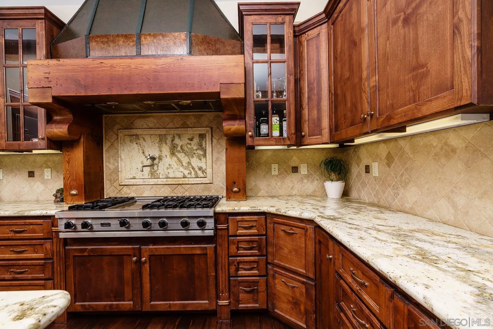 31781 Wrightwood Road Bonsall, CA 92003 - Photo 11 of 46 a kitchen with stainless steel appliances granite countertop a stove and a wooden cabinets