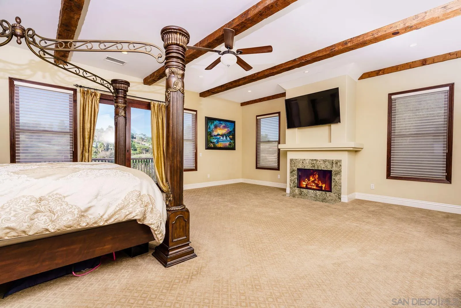 31781 Wrightwood Road Bonsall, CA 92003 - Photo 15 of 46 a bed sitting in a room next to a fireplace