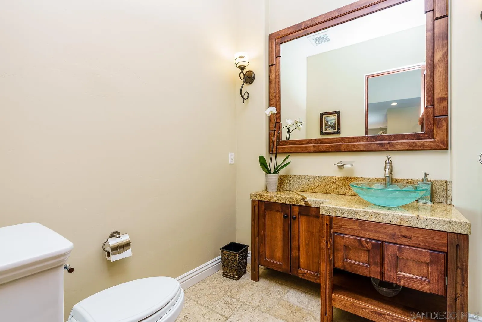 31781 Wrightwood Road Bonsall, CA 92003 - Photo 19 of 46 a bathroom with a granite countertop toilet sink and mirror