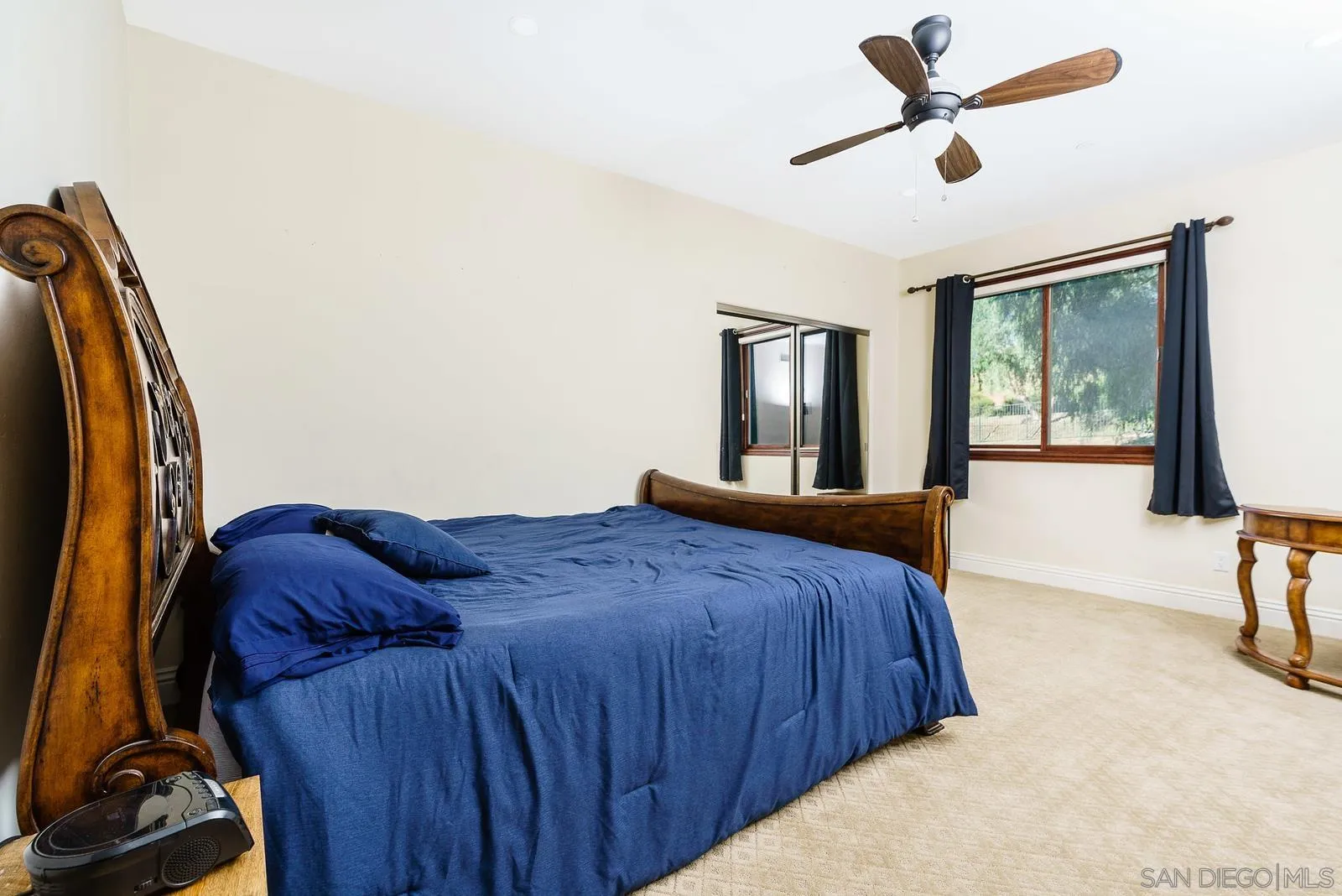 31781 Wrightwood Road Bonsall, CA 92003 - Photo 21 of 46 a bedroom with a bed and a chandelier