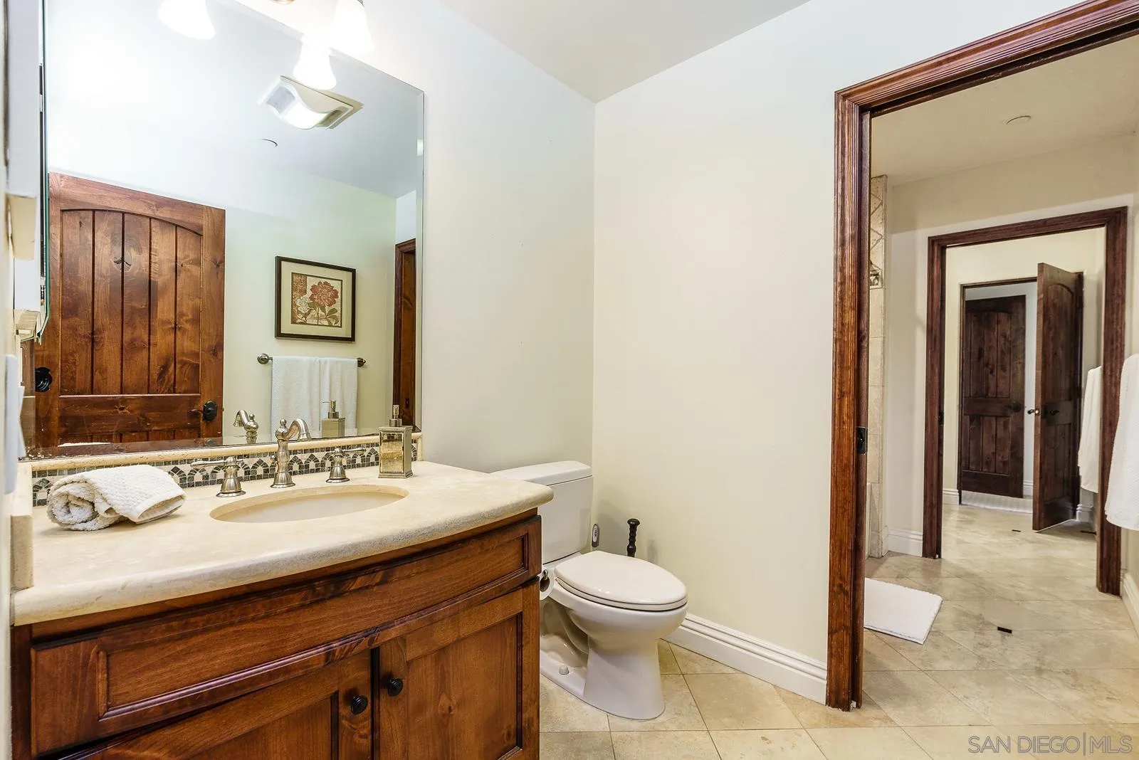 31781 Wrightwood Road Bonsall, CA 92003 - Photo 22 of 46 a bathroom with a sink mirror and toilet