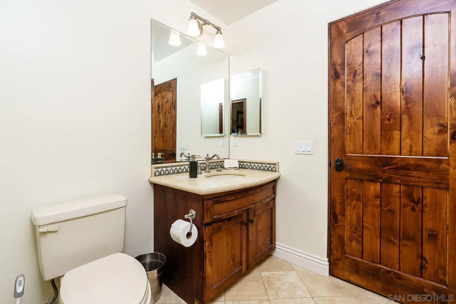 31781 Wrightwood Road Bonsall, CA 92003 - Photo 30 of 46 a bathroom with a toilet a sink and mirror