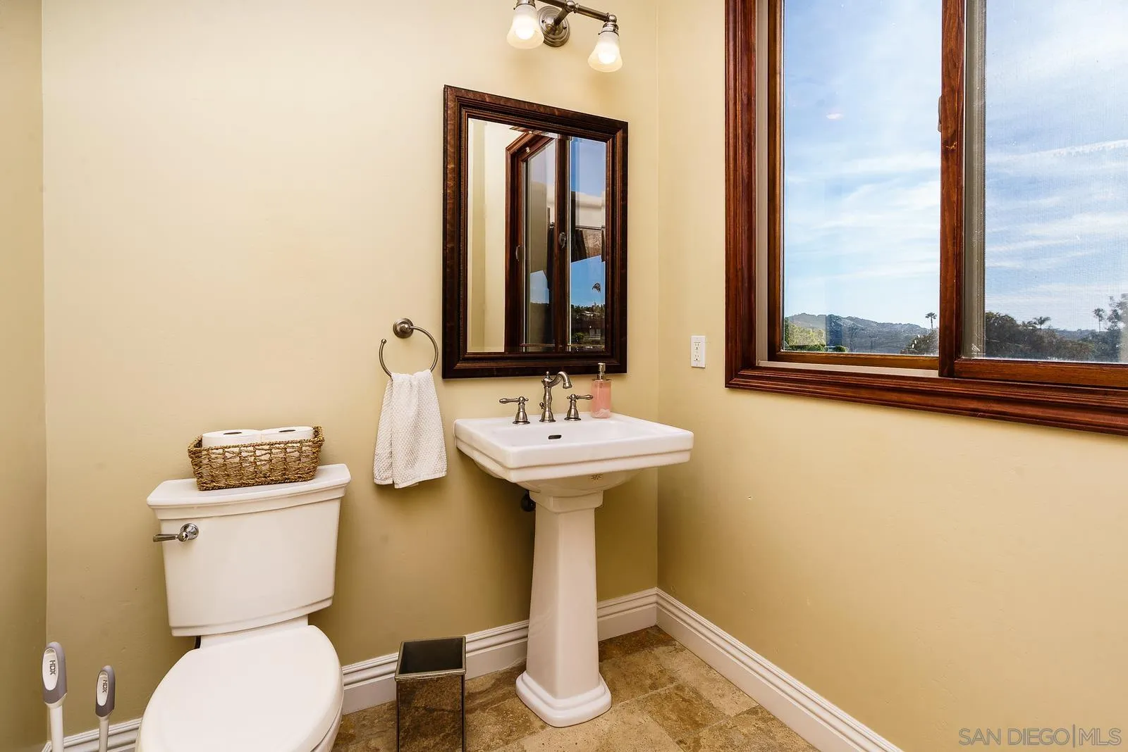 31781 Wrightwood Road Bonsall, CA 92003 - Photo 33 of 46 a bathroom with a toilet sink and mirror