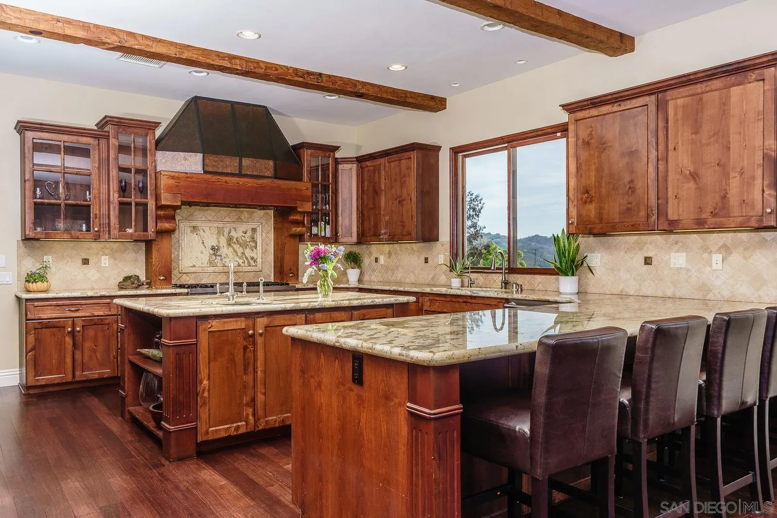31781 Wrightwood Road Bonsall, CA 92003 - Photo 9 of 46 a kitchen with stainless steel appliances granite countertop a stove a sink dishwasher and cabinets with wooden floor