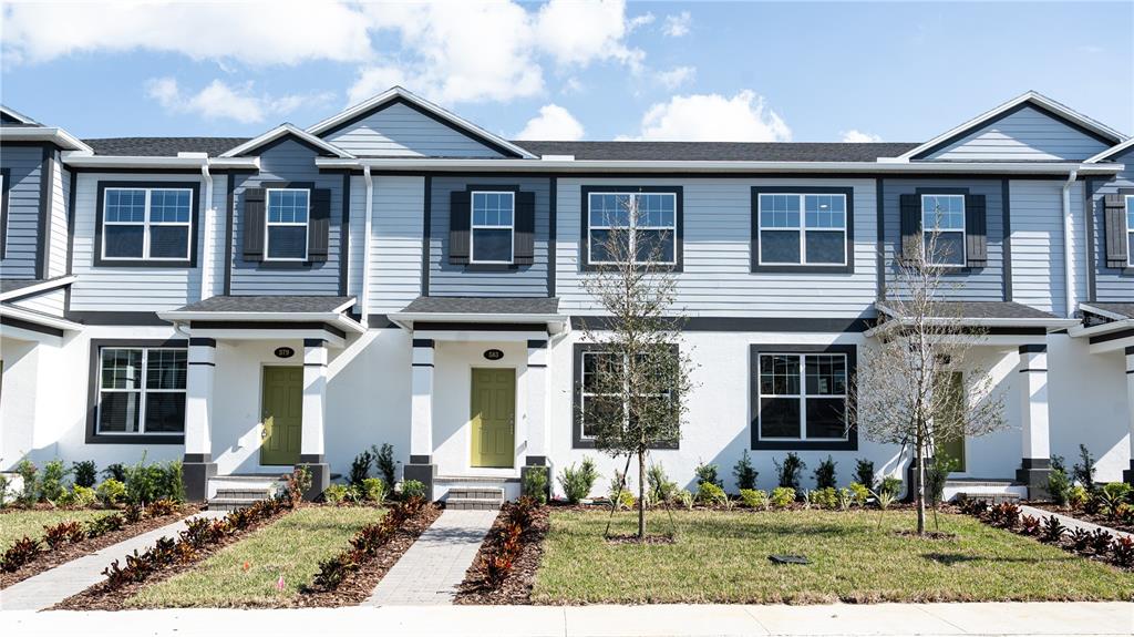 583 Pothos Street Apopka, FL 32703 - Photo 1 of 26 a front view of a house with garden