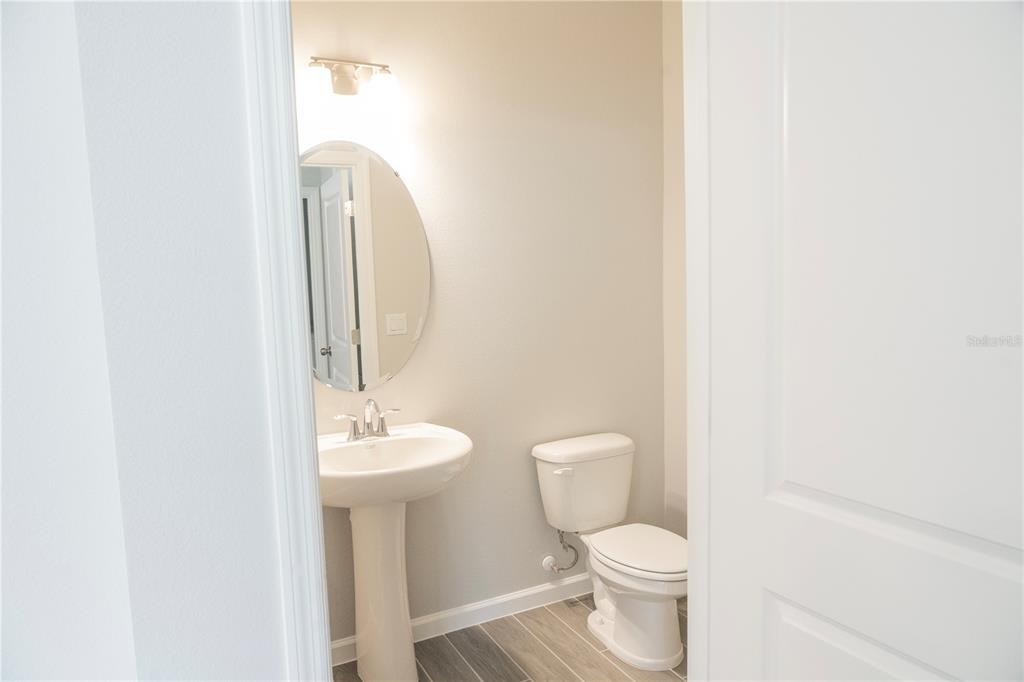 583 Pothos Street Apopka, FL 32703 - Photo 11 of 26 a bathroom with a toilet a sink and a mirror
