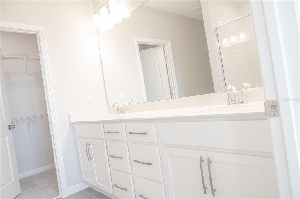 583 Pothos Street Apopka, FL 32703 - Photo 15 of 26 a bathroom with a sink and a mirror