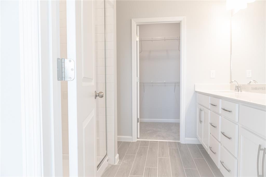 583 Pothos Street Apopka, FL 32703 - Photo 16 of 26 a bathroom with a shower and a sink