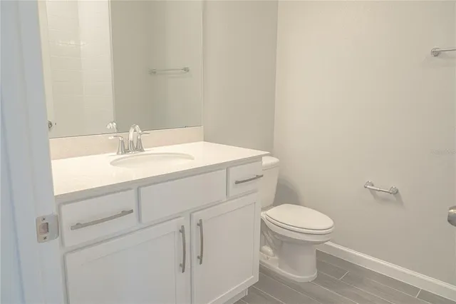 a bathroom with a sink toilet and a mirror
