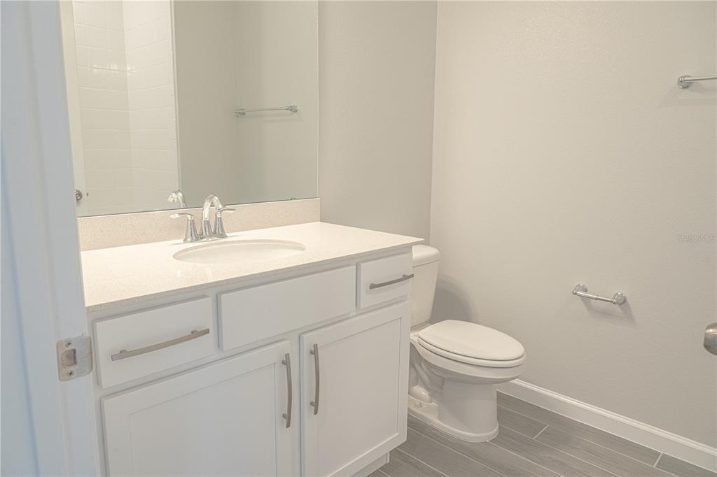 583 Pothos Street Apopka, FL 32703 - Photo 20 of 26 a bathroom with a sink toilet and a mirror