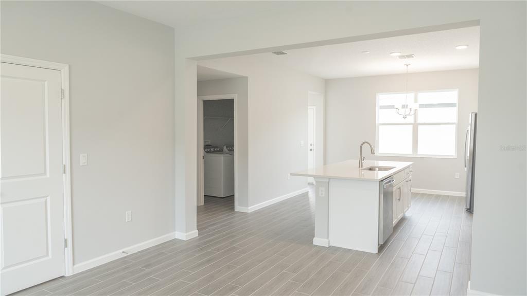 583 Pothos Street Apopka, FL 32703 - Photo 6 of 26 a kitchen with a sink and a refrigerator