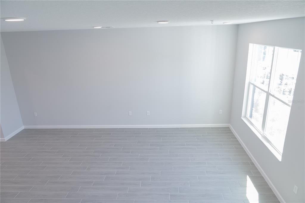 583 Pothos Street Apopka, FL 32703 - Photo 8 of 26 a view of an empty room with a window