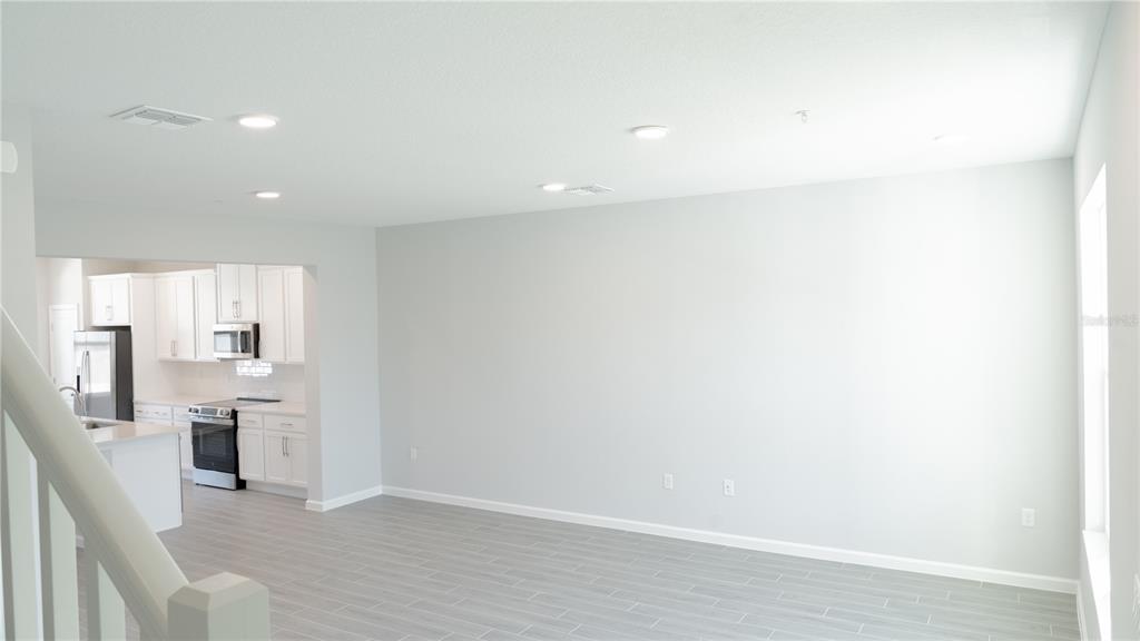 583 Pothos Street Apopka, FL 32703 - Photo 9 of 26 a view of a kitchen with white cabinets