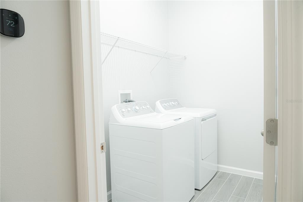 583 Pothos Street Apopka, FL 32703 - Photo 10 of 26 a utility room with dryer and washer