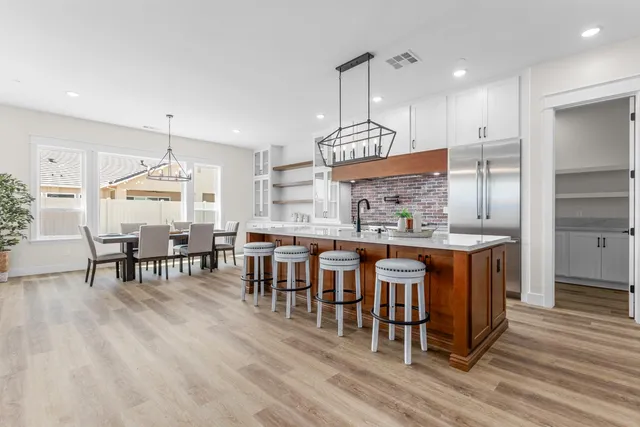 a large kitchen with a table and chairs