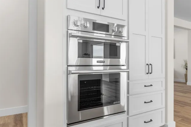 a kitchen with cabinets and stainless steel appliances