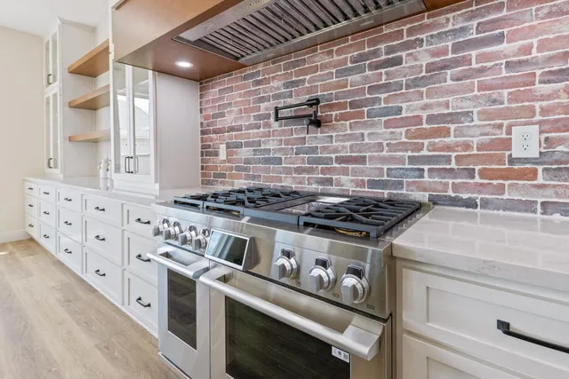 a stove top oven sitting inside of a kitchen