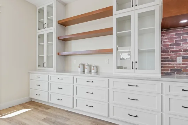 a kitchen with cabinets and window