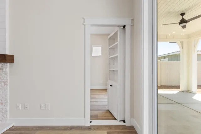 a view of a hallway with wooden floor and closet