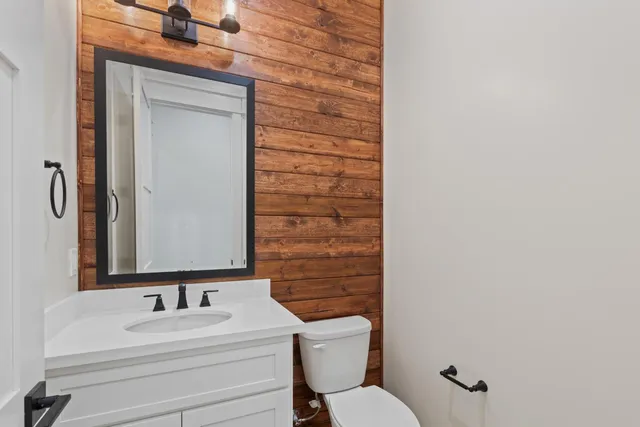 a kitchen with stainless steel appliances granite countertop a sink a stove and dishwasher with wooden cabinets
