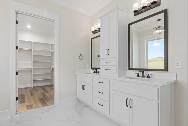 a bathroom with a double vanity sink and mirror
