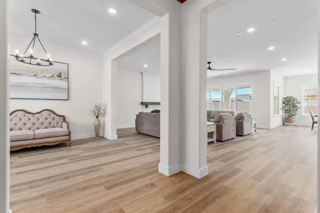 a view of a bedroom with furniture and wooden floor