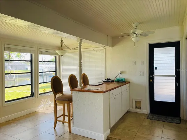 a bedroom with a bed flat screen tv and a chandelier