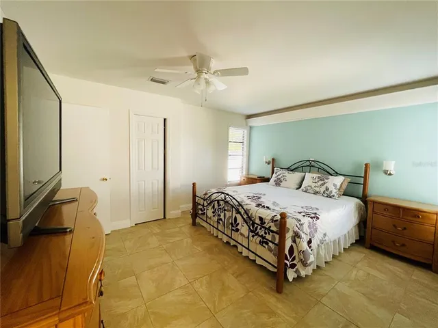 a bedroom with a bed and a chandelier