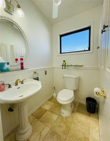 a large white kitchen with a large window and stainless steel appliances