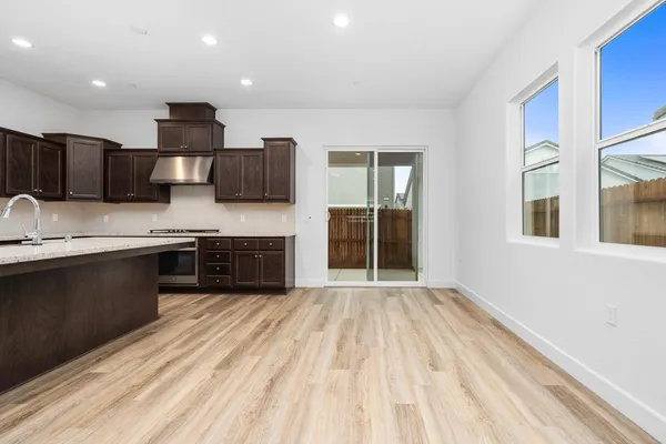a kitchen with stainless steel appliances granite countertop a sink and a stove top oven