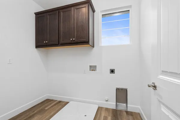 a view of a closet area with hardwood floor