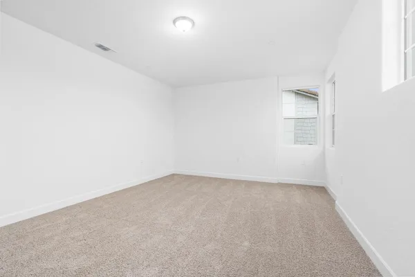 an empty room with a empty space and windows