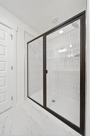 a bathroom with a glass shower door