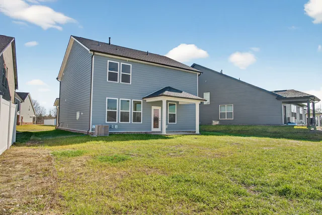 a view of a house with a yard and garage