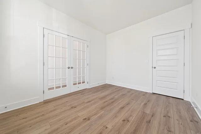 an empty room with wooden floor