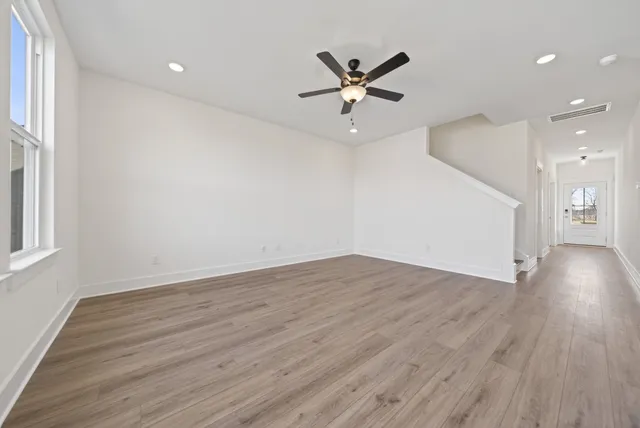 wooden floor in an empty room with a window