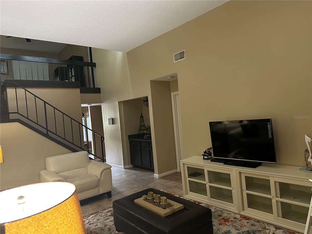 600 Cranes Way, Unit 204 Altamonte Springs, FL 32701 - Photo 13 of 26 a living room with furniture and a flat screen tv