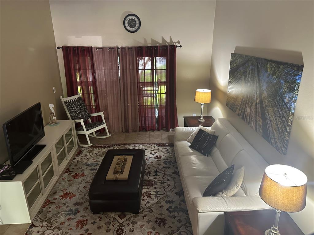 600 Cranes Way, Unit 204 Altamonte Springs, FL 32701 - Photo 14 of 26 a living room with furniture and a flat screen tv