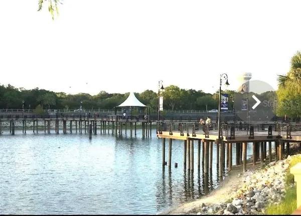 a balcony with outdoor seating and water view