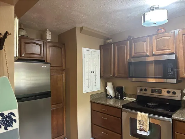 a kitchen with stainless steel appliances granite countertop a stove and a refrigerator