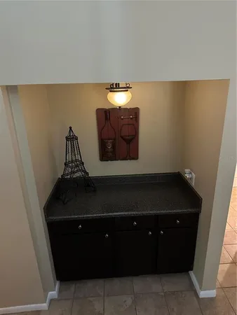 a room with a cabinet and a potted plant