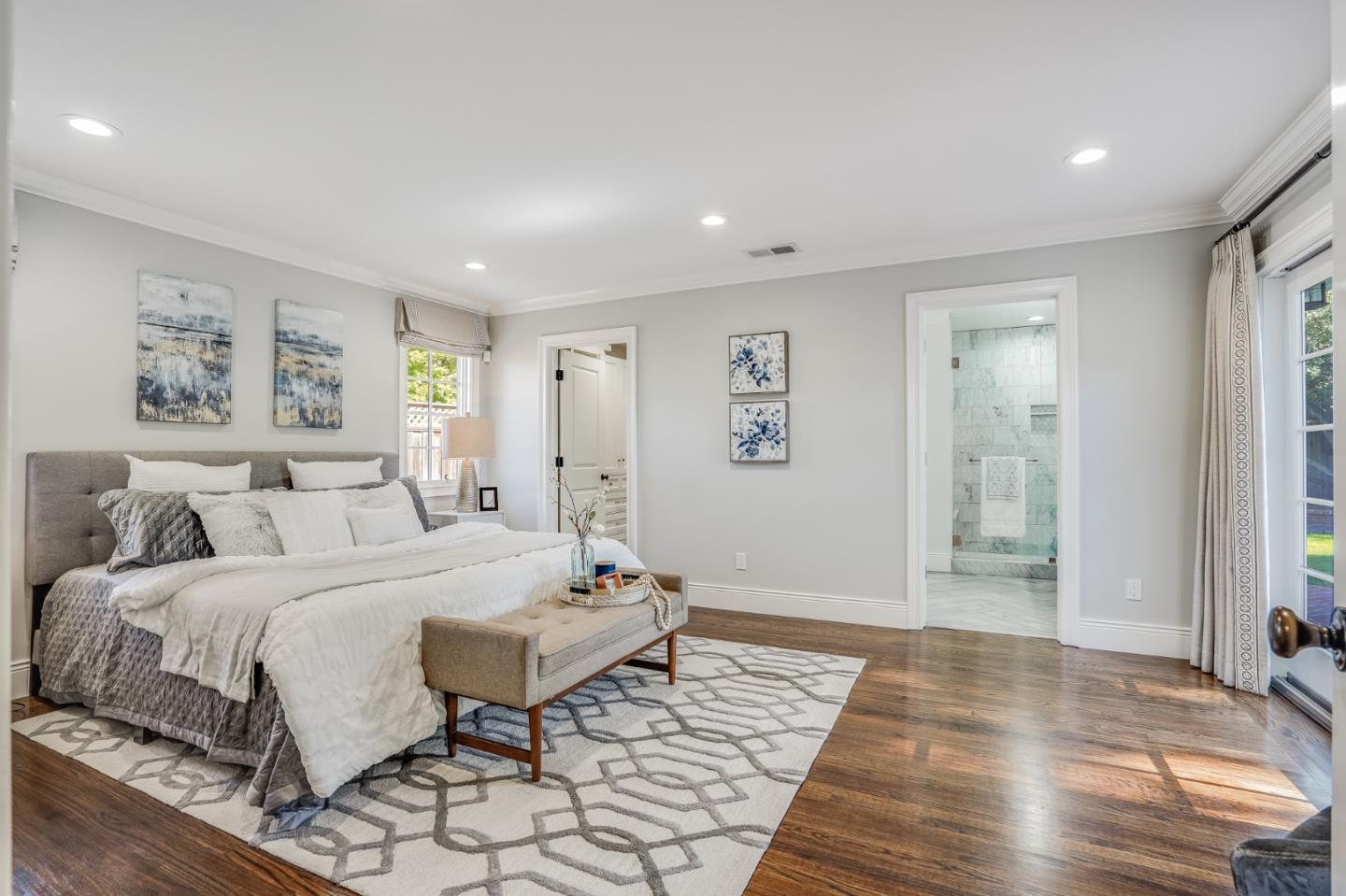 1481 Brookmill Road Los Altos, CA 94024 - Photo 23 of 55 a spacious bedroom with a bed and wooden floor