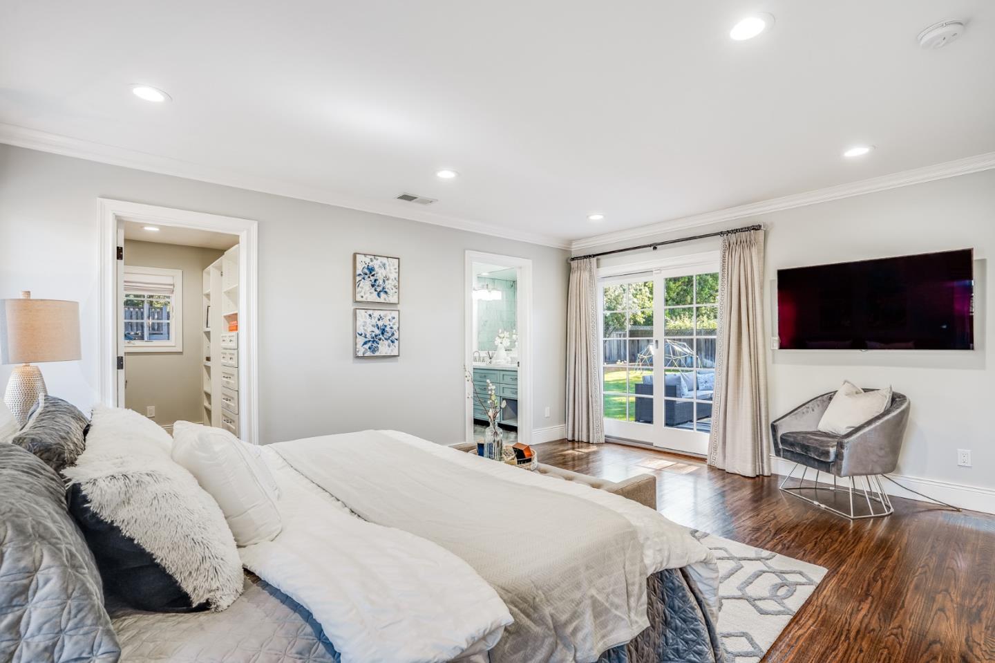 1481 Brookmill Road Los Altos, CA 94024 - Photo 25 of 55 a bedroom with a bed and a flat screen tv