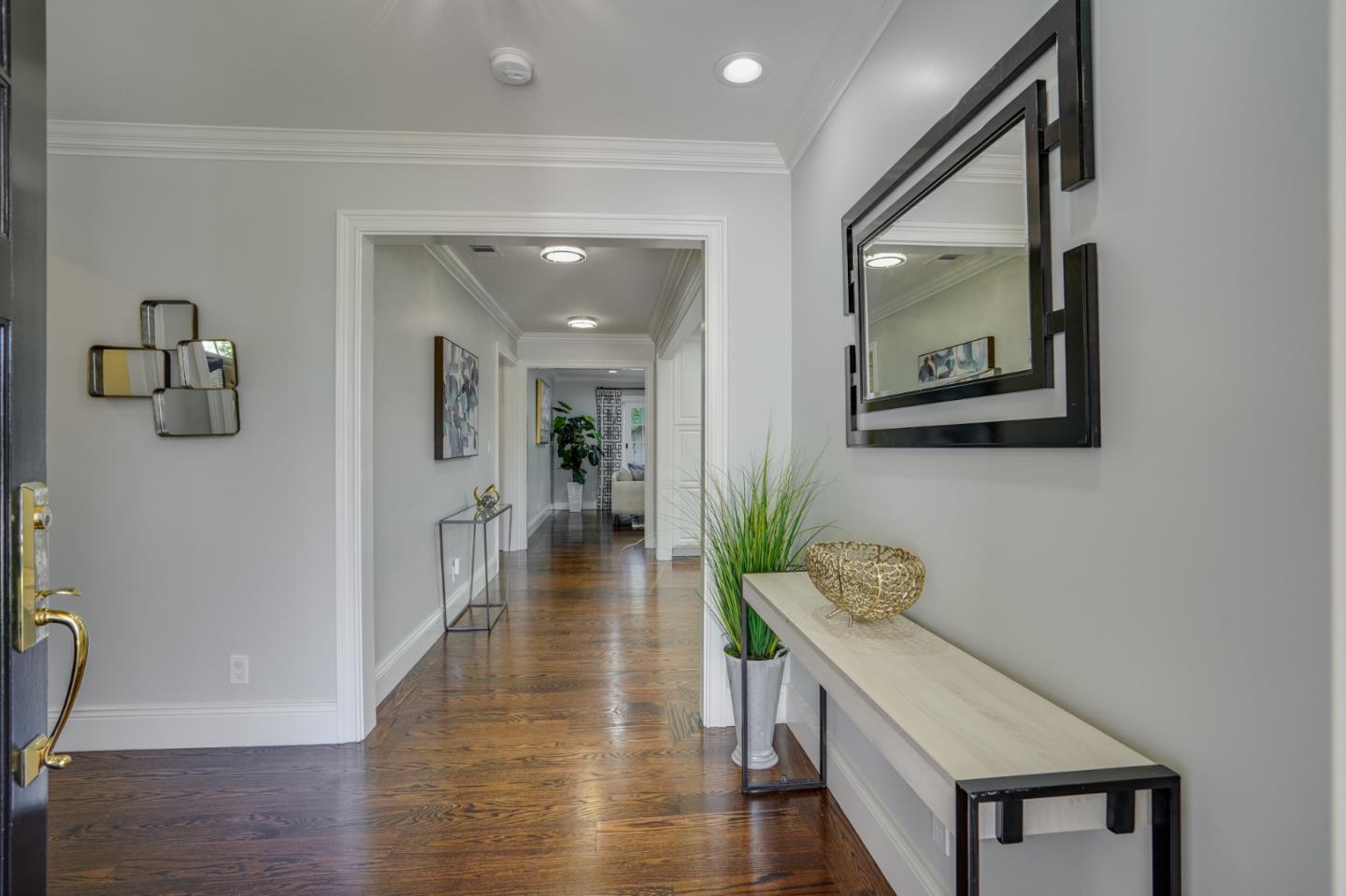 1481 Brookmill Road Los Altos, CA 94024 - Photo 4 of 55 a hallway with wooden floor table and chairs