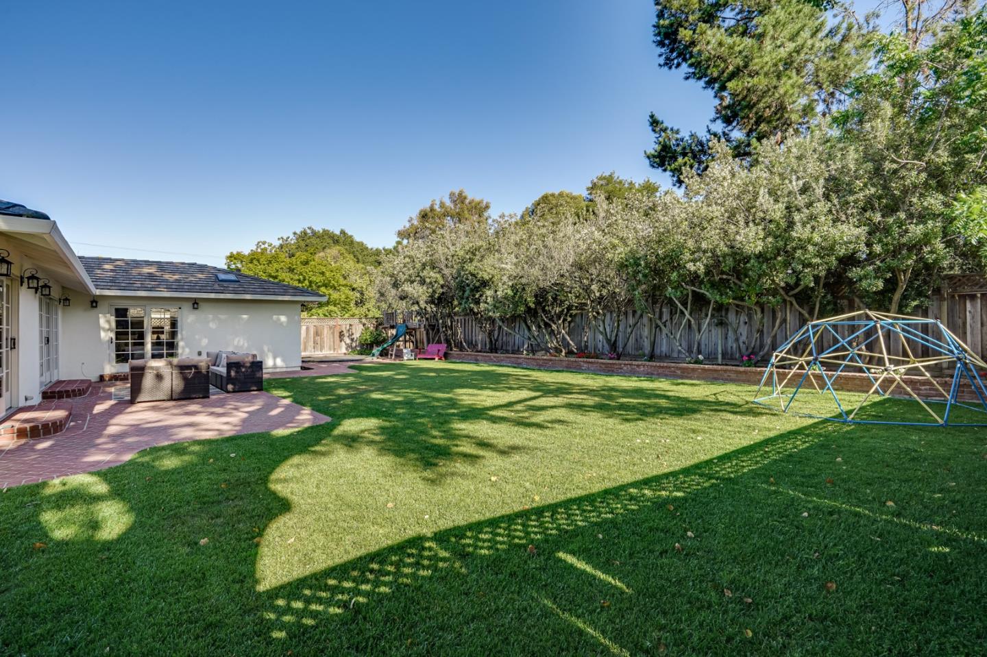 1481 Brookmill Road Los Altos, CA 94024 - Photo 42 of 55 a view of a backyard with table and chairs and a slide