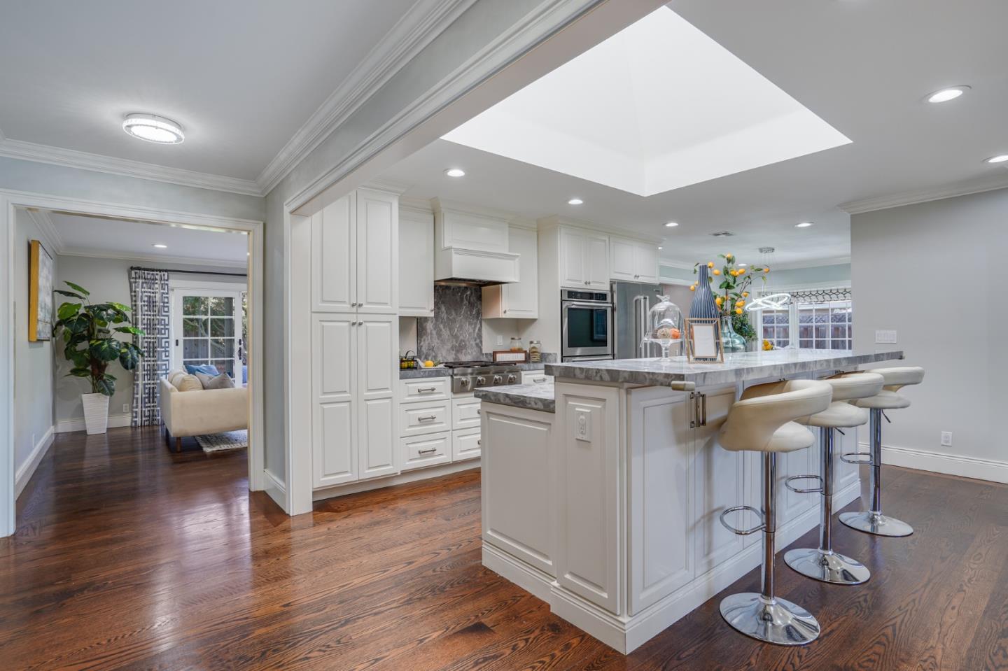 1481 Brookmill Road Los Altos, CA 94024 - Photo 6 of 55 a kitchen with stainless steel appliances granite countertop a refrigerator a stove top oven a sink dishwasher and white cabinets with wooden floor